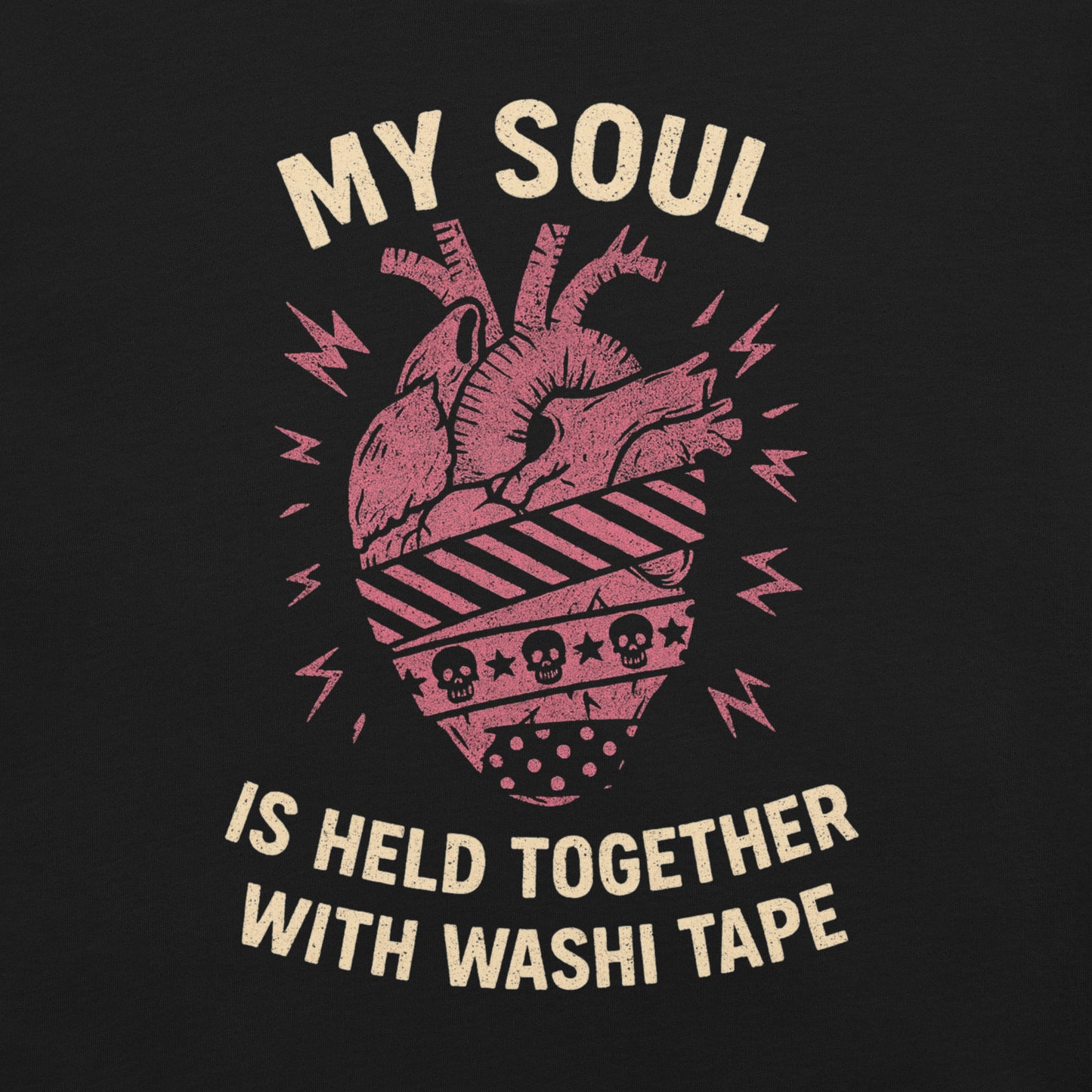 Closeup of graphic. Tee has a red anatomical heart with three different patterns of washi tape wrapping around it. Text says "my soul is held together with washi tape."