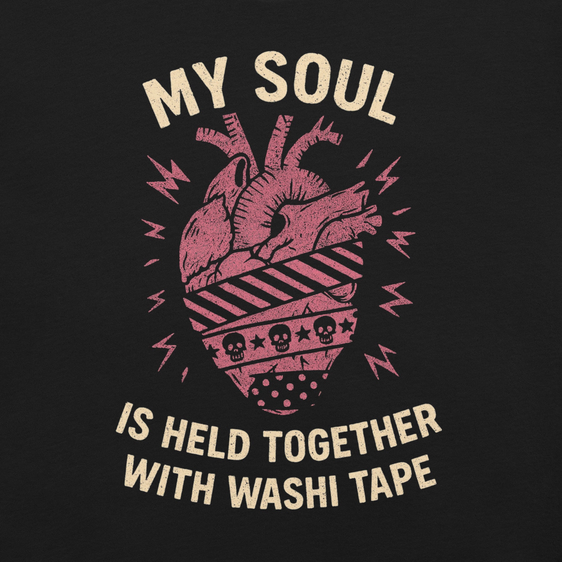 Closeup of graphic. Tee has a red anatomical heart with three different patterns of washi tape wrapping around it. Text says "my soul is held together with washi tape."