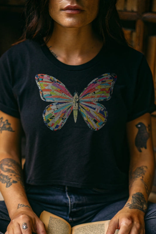 A colorful, collaged butterfly graphic on a black t-shirt.