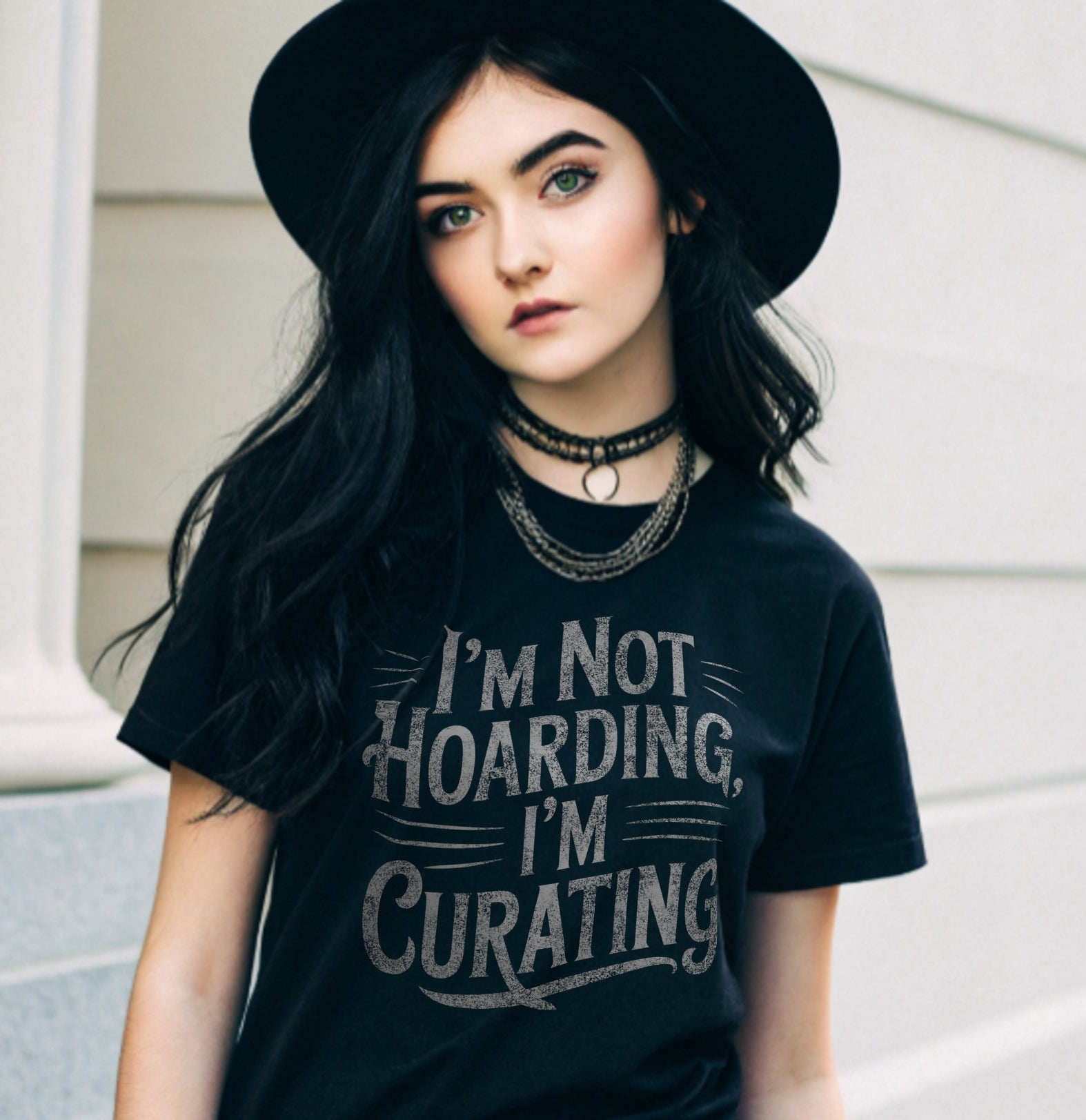 Person wearing a black t-shirt with 'I'm Not Hoarding, I'm Curating' text.