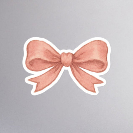 Pink coquette aesthetic bow sticker with white kiss cut border.